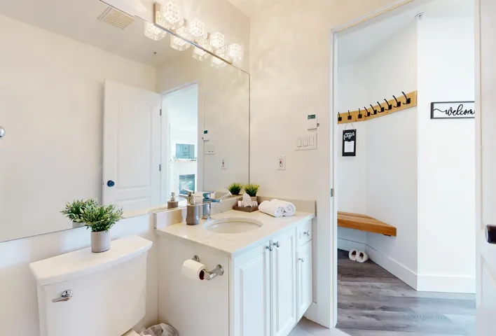 Half bath with vanity and light wood finished floors