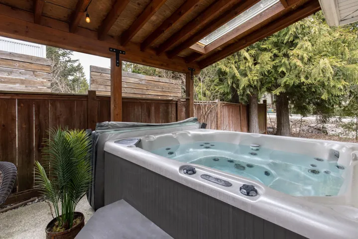 View of patio / terrace with fence and a hot tub