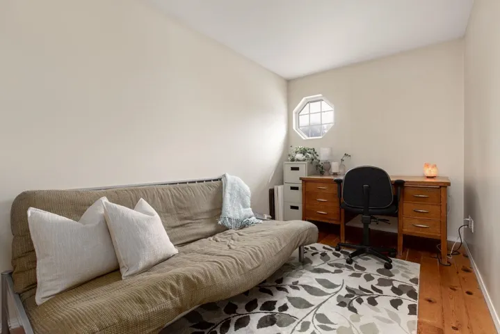 Home office with wood finished floors and baseboards