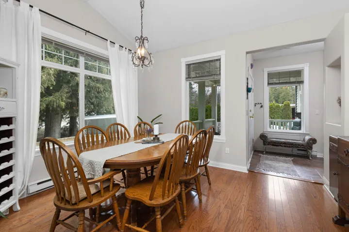 Dining area featuring wood-type flooring, lofted ceiling, and a wealth of natural light