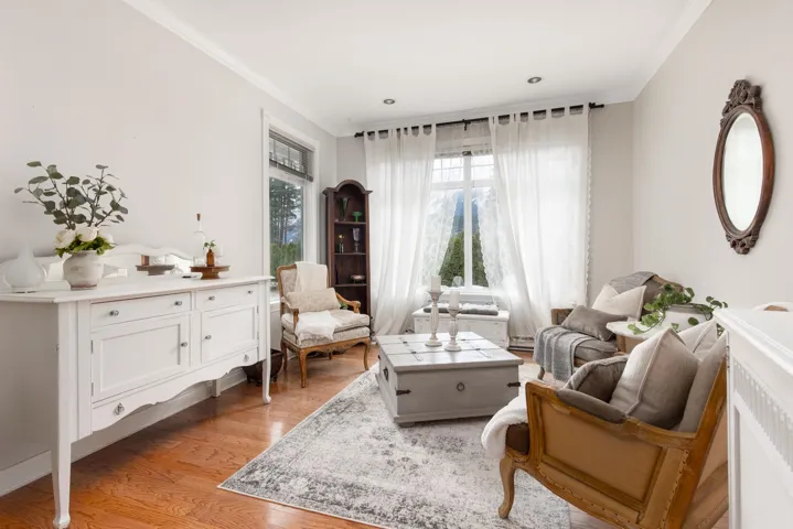 Sitting room featuring light wood finished floors and ornamental molding