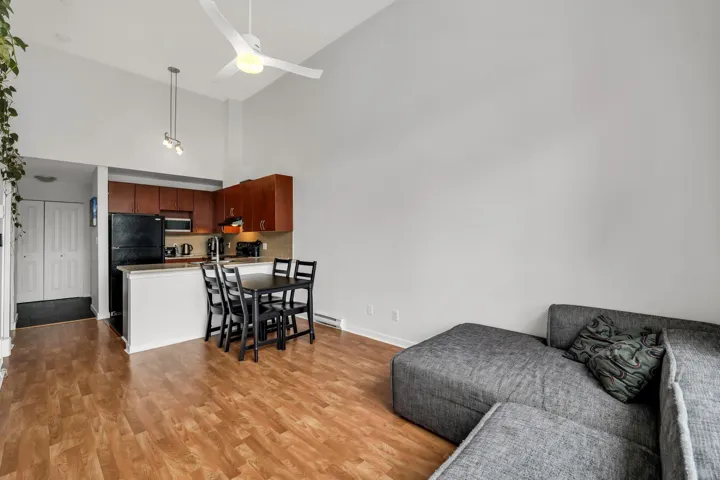 Living room featuring light wood-type flooring and lofted ceiling