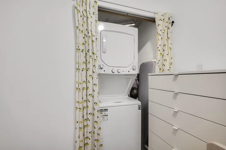 Laundry area with stacked washing machine and dryer