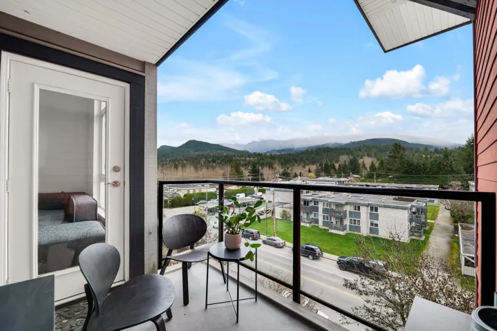 Balcony featuring a mountain view and a wooded view