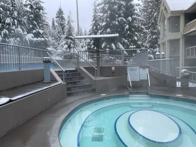 View of pool featuring a deck and stairs