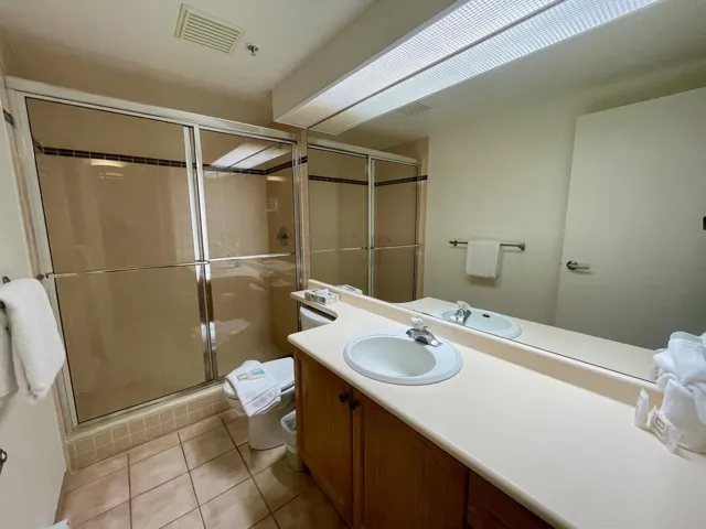 Bathroom with vanity, visible vents, a stall shower, tile patterned floors, and toilet