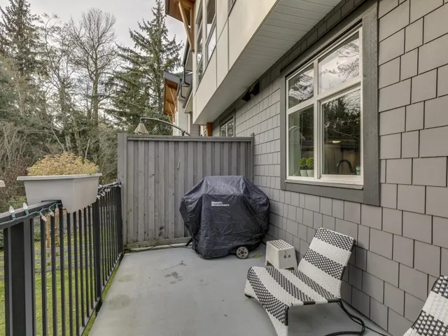 View of patio with a grill