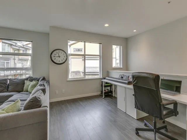 Office space featuring wood finished floors and recessed lighting