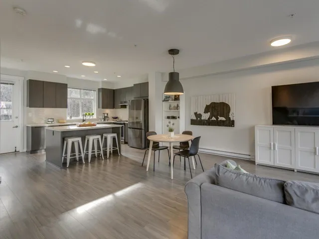 Living room featuring recessed lighting, light wood-type flooring, and a baseboard heating unit