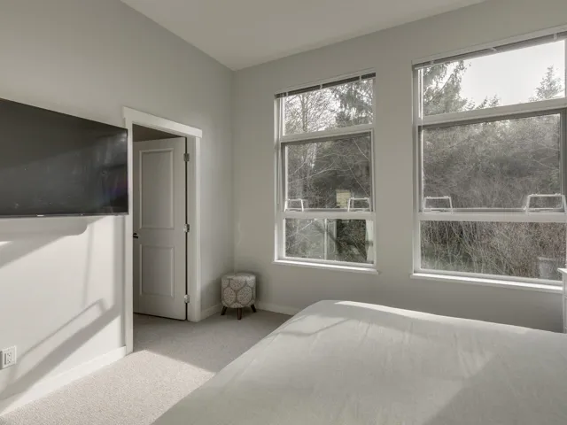 Bedroom with light carpet and baseboards