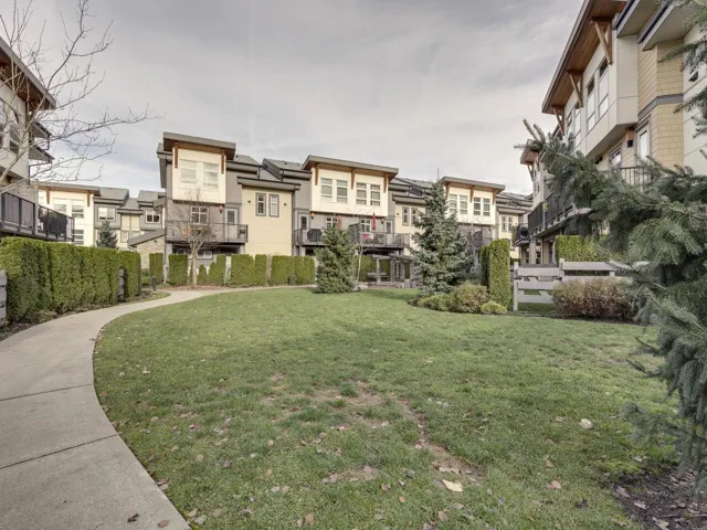 View of community with a residential view, a yard, and a balcony