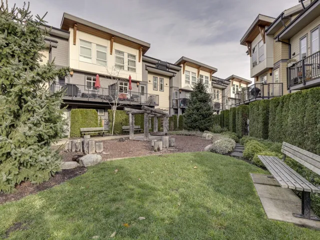 View of grassy yard with a balcony and a residential view