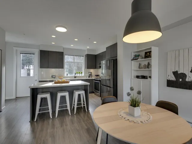 Dining space with dark wood-style flooring and recessed lighting