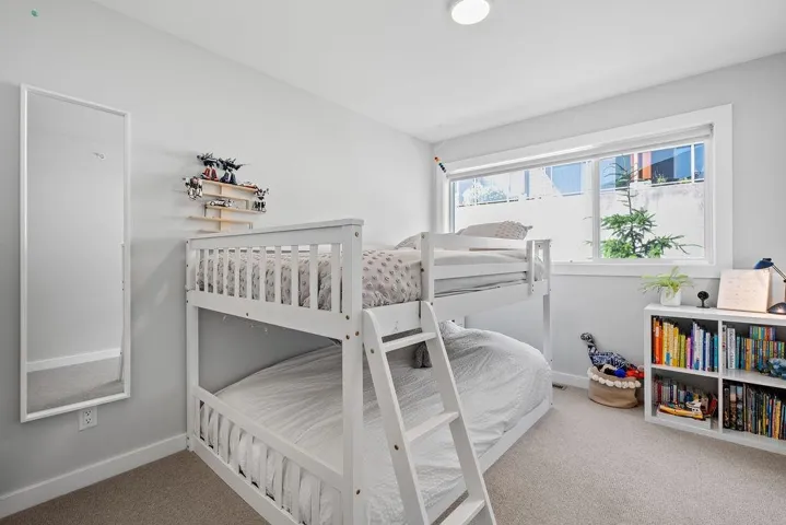 Bedroom featuring carpet flooring and baseboards