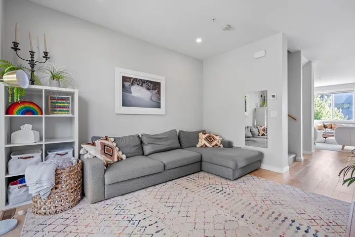 Living area with wood finished floors and recessed lighting