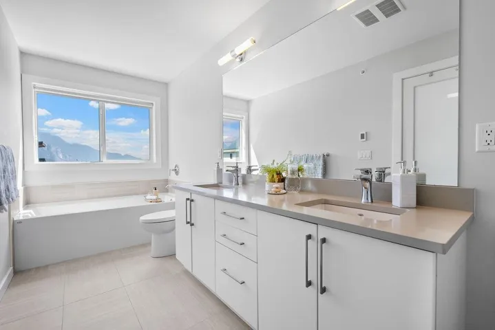 Bathroom with double vanity and a garden tub