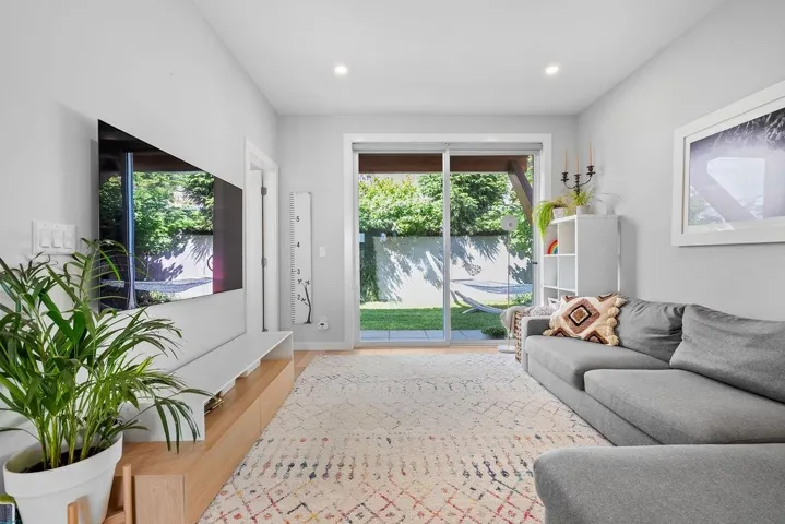 Living room with wood finished floors and recessed lighting