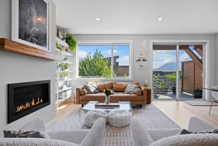 Living area featuring wood finished floors, recessed lighting, and a fireplace