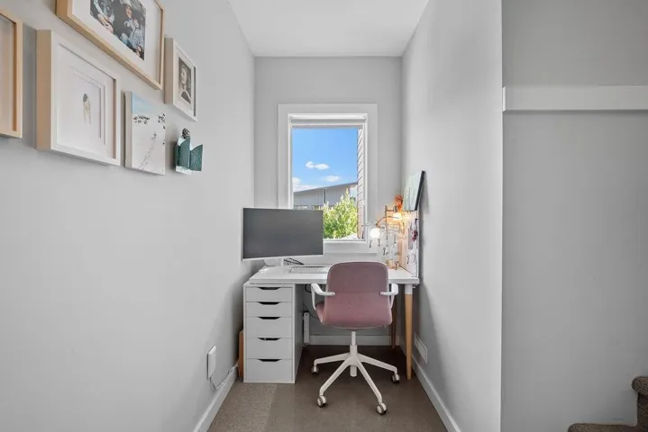 Carpeted home office with baseboards