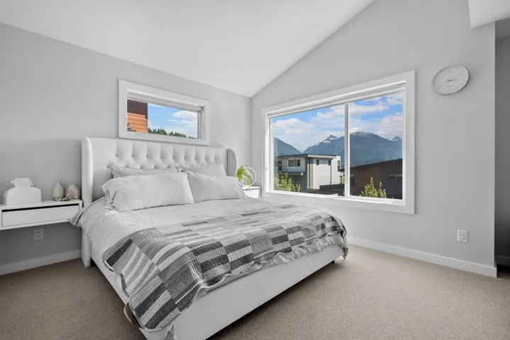 Bedroom featuring carpet flooring and lofted ceiling
