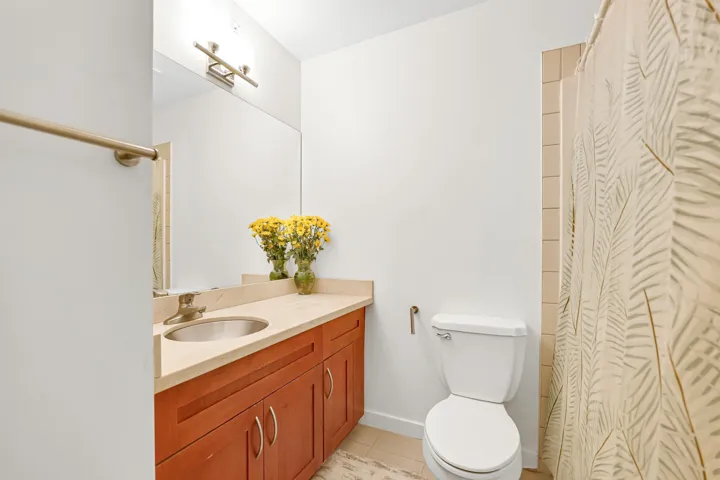 Full bathroom featuring vanity, tile patterned flooring, toilet, curtained shower, and baseboards