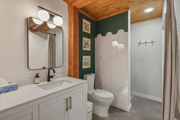 Full bath with wood ceiling, light tile patterned floors, vanity, a shower with shower curtain, and recessed lighting