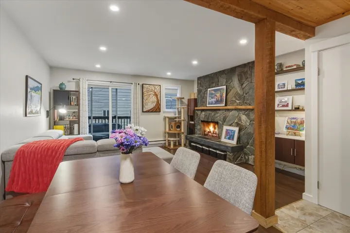 Dining space with a stone fireplace and recessed lighting