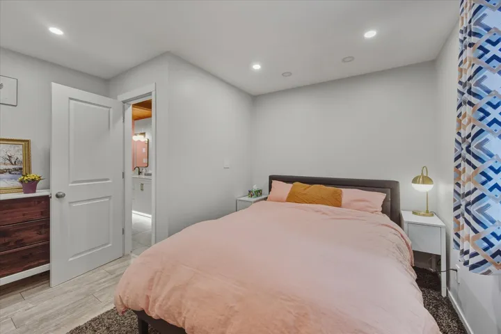 Bedroom with light wood-style floors and recessed lighting