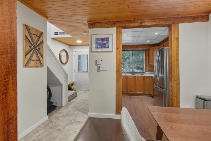 Kitchen featuring light countertops, brown cabinets, recessed lighting, freestanding refrigerator, and light wood-style floors