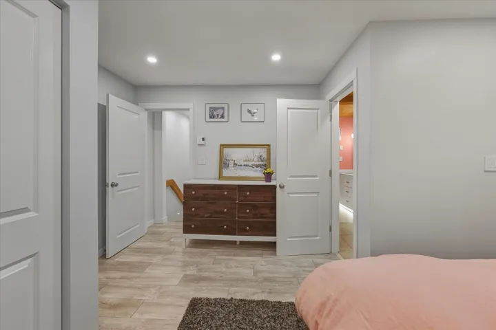 Bedroom with light wood-style floors and recessed lighting