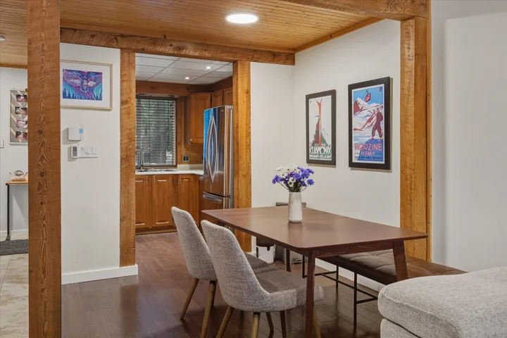 Dining area with dark wood-type flooring, recessed lighting, and wooden ceiling
