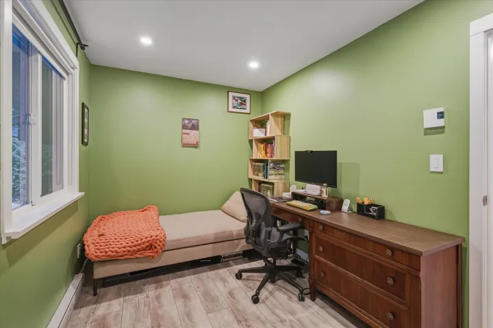 Home office with light wood-style floors, a baseboard heating unit, and recessed lighting