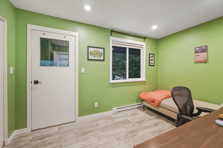 Home office featuring wood tiled floors, a baseboard radiator, and recessed lighting
