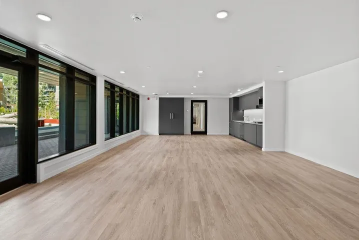 Expansive open-concept space featuring wood-finish flooring and recessed lighting