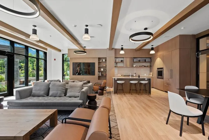 Expansive open-concept space featuring wood-finish flooring and integrated wood paneling