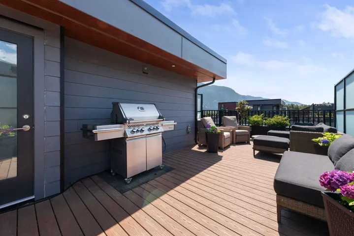 Wooden deck featuring a mountain view, area for grilling, and an outdoor hangout area