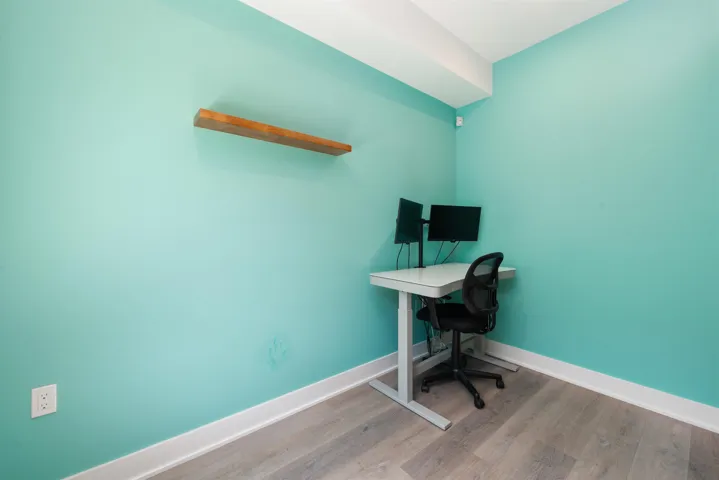 Unfurnished office with wood finished floors and baseboards