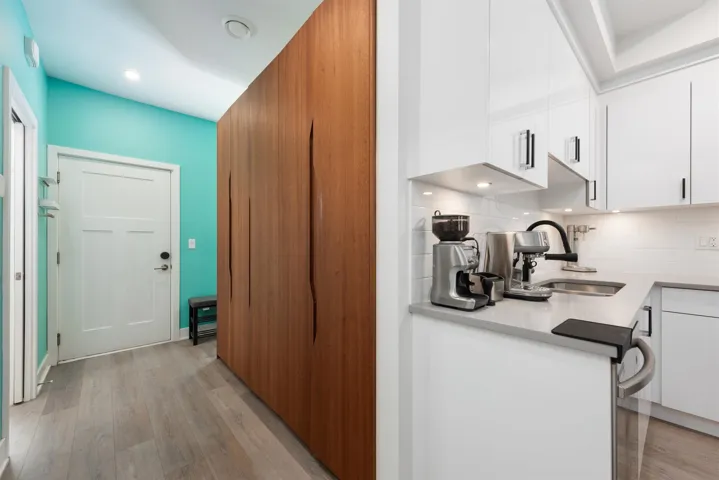 Kitchen featuring white cabinets, decorative backsplash, modern cabinets, and recessed lighting