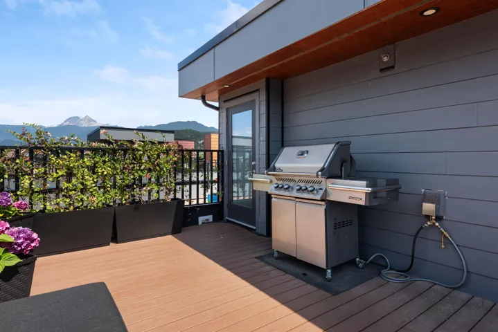 Wooden terrace with a mountain view and grilling area