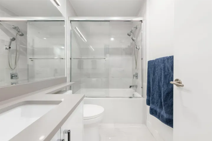 Bathroom with vanity and shower / bath combination with glass door