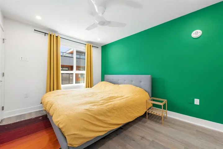 Bedroom featuring wood finished floors, ceiling fan, and recessed lighting