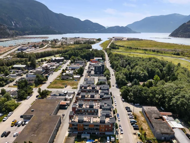 Aerial view of property and surrounding area featuring a water and mountain view