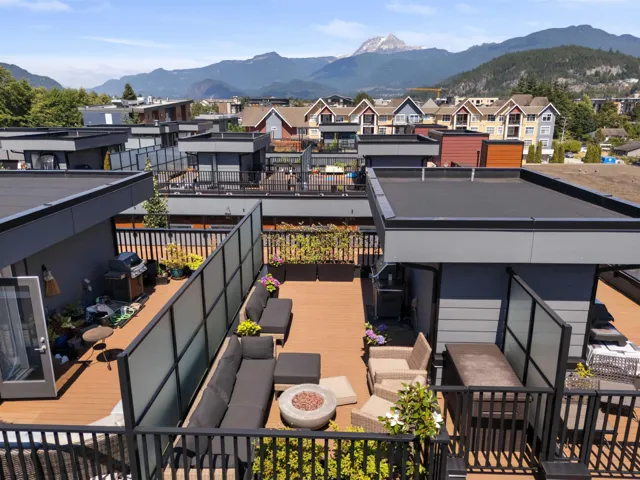 Wooden deck with a mountain view, area for grilling, and a residential view
