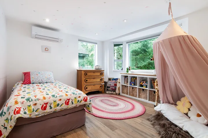 Bedroom featuring wood finished floors, an AC wall unit, and recessed lighting