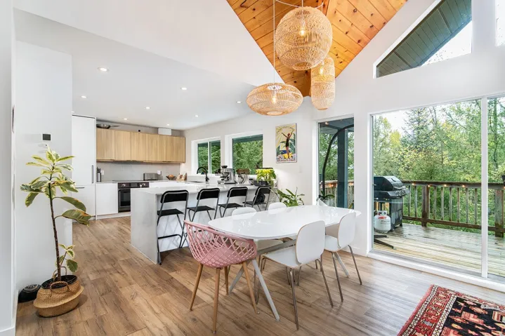 Dining room featuring high vaulted ceiling, light wood-style flooring, and recessed lighting
