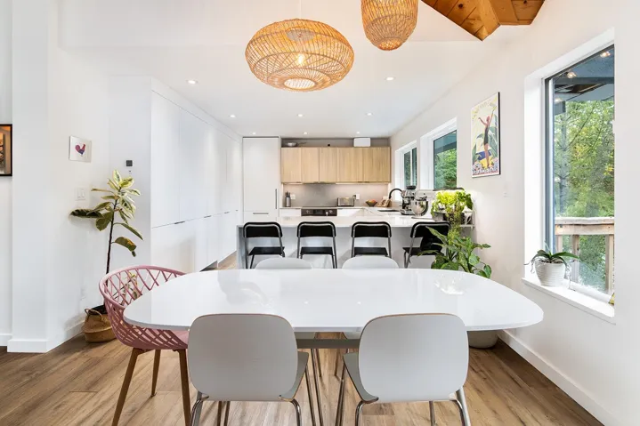 Dining room with light wood-style flooring and recessed lighting