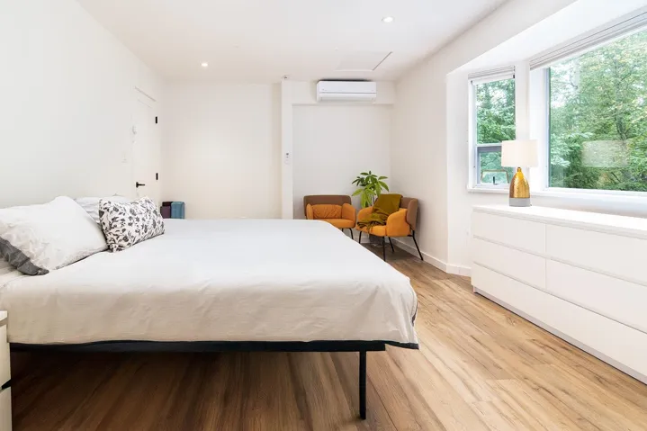 Bedroom with attic access, recessed lighting, light wood-style flooring, and a wall mounted AC