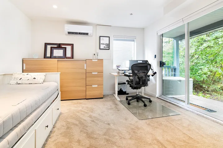 Bedroom featuring light colored carpet, an office area, access to outside, and a wall mounted air conditioner