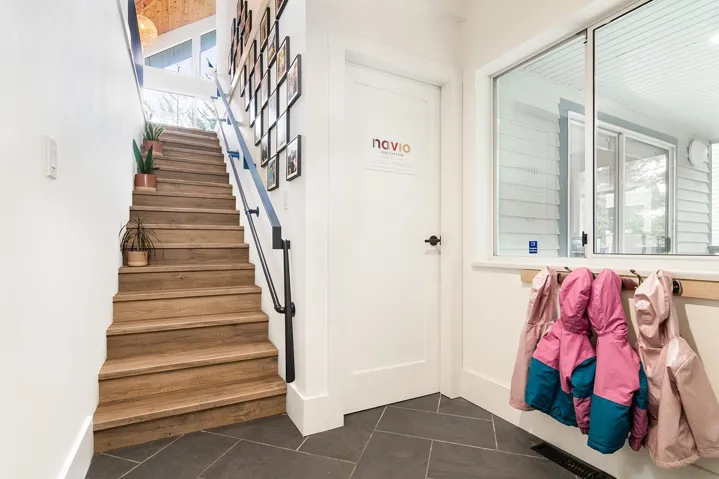 Stairway featuring tile patterned floors and baseboards