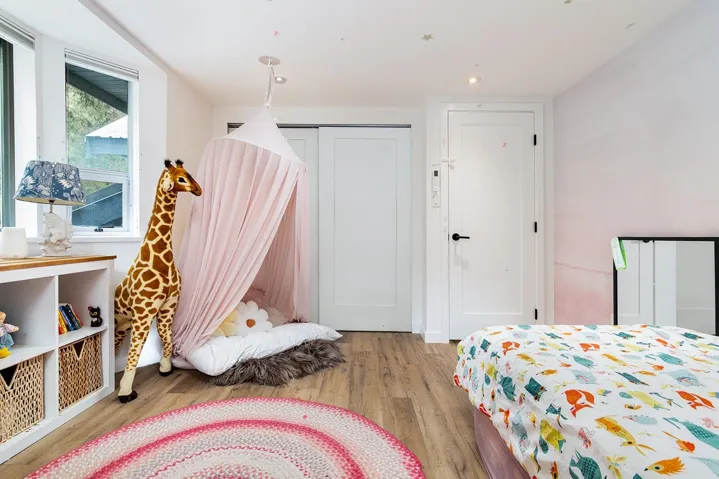Bedroom featuring light wood-style floors and a closet